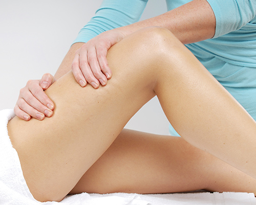 woman recieving massage treatment on her injured leg