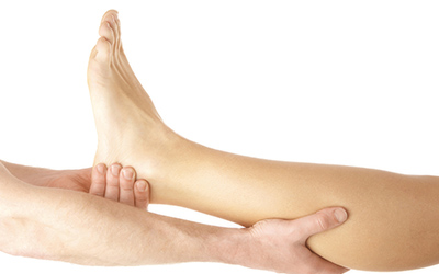 A close up of a patients leg being examined by a physiotherapist