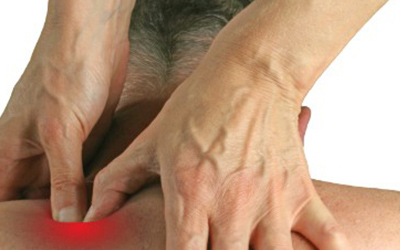A close up of a physiotherapist performing treatment on a patients injured shoulder