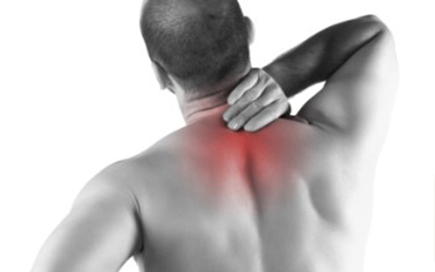 A man's upper back with his neck area highligted indicating that he is suffering discomfort